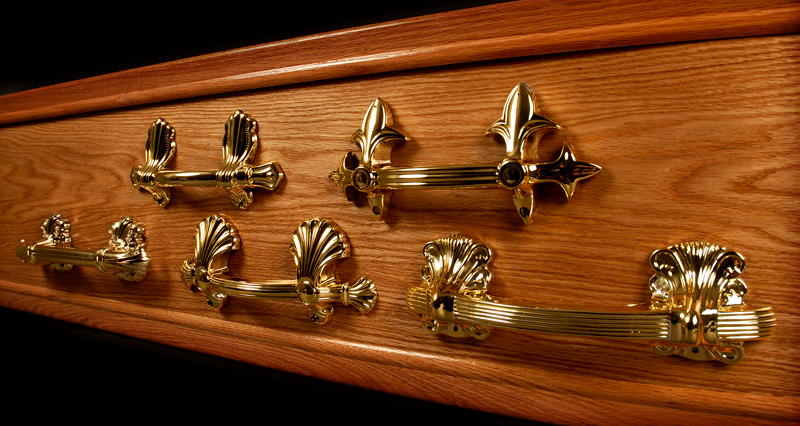 Showing 5 cremation handles of various designs.